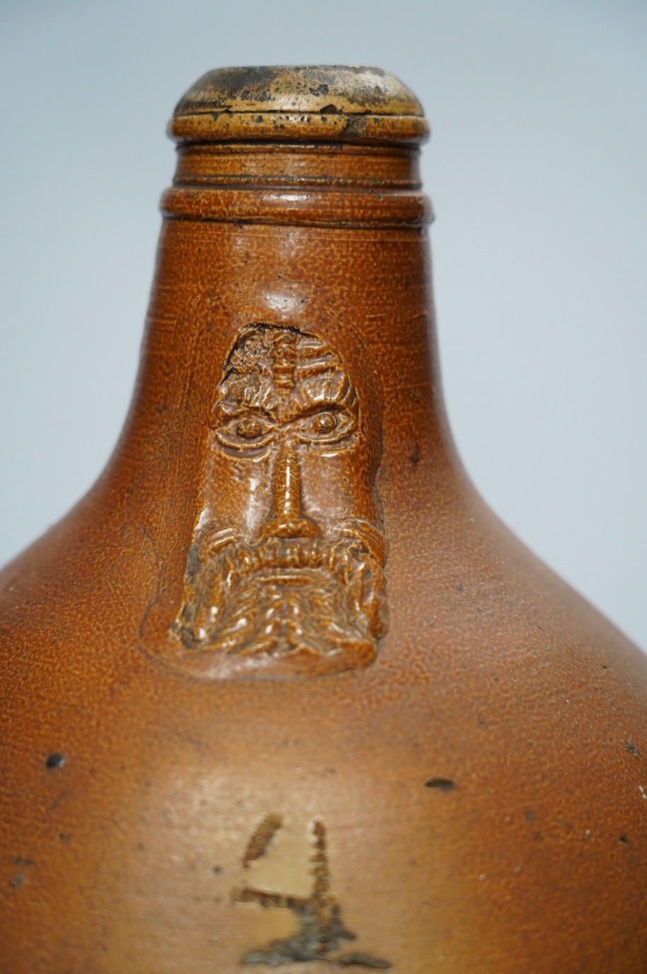 An 18th century German large salt glazed Bellarmine, 45cm. Condition - commensurate with age